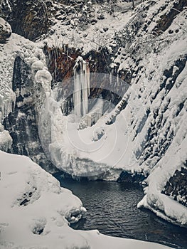 Huk waterfall, frozen waterfall at winter, Carpathian National Park. Ukraine.