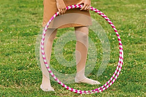 Hula hoop massage hoop for weight loss on the background of grass in the open air, close-up. outdoor