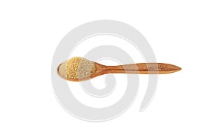 Hulbah powder or Fenugreek flour in wooden spoon isolated on white background, selective focus. Herbal nutritional supplement.