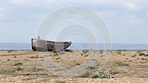 The hull of an abandoned fishing boat on Dungeness beach