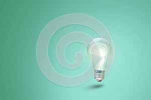 Human brain glowing inside of light bulb