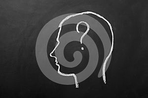 Human brain and question mark draw on blackboard