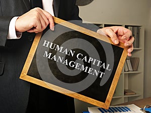 Human capital management HCM written on the blackboard