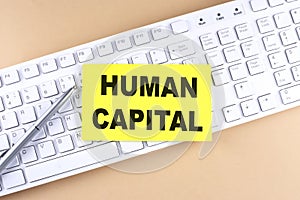 HUMAN CAPITAL text on a sticky on keyboard, business concept