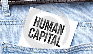 Human Capital words on a white paper stuck out from jeans pocket. Business concept