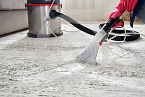 Human Cleaning Carpet In The Living Room Using Vacuum Cleaner At Home