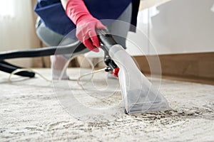 Human Cleaning Carpet In The Living Room Using Vacuum Cleaner At Home