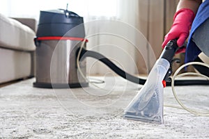 Human Cleaning Carpet In The Living Room Using Vacuum Cleaner At Home