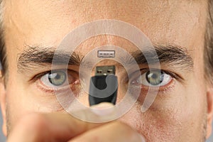 Human connects wire to the connector on his face between eyes, closeup, concept