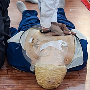 Human dummy lies on the floor during first Aid Training - Cardiopulmonary resuscitation. First aid course on CPR dummy, CPR First