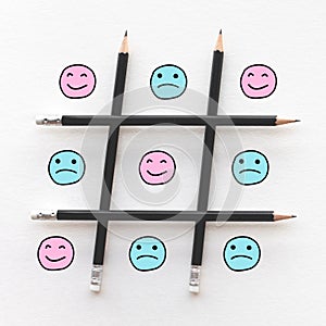 Human emotion concepts with emoticon face happy and sad in game line pattern photo
