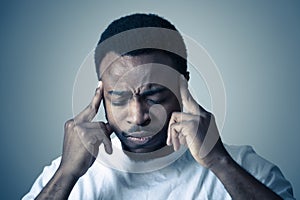 Human expressions and emotions. Young attractive man with migraines. Suffering strong pain