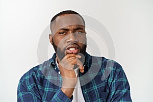 Human face expressions, emotions and feelings. Handsome young African American man looking up with thoughtful and