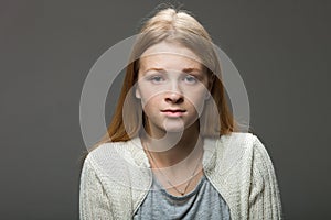 Human face expressions and emotions. Portrait of young adorable redhead woman in cozy shirt looking calm and happy.