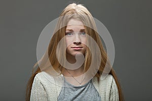 Human face expressions and emotions. Portrait of young adorable redhead woman with pouting lips in cozy shirt looking confused.