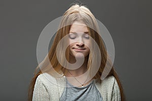 Human face expressions and emotions. Portrait of young adorable redhead woman with pouting lips in cozy shirt looking confused.