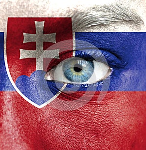 Human face painted with flag of Slovakia