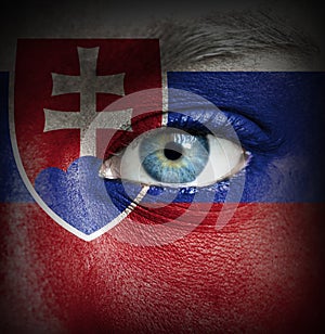 Human face painted with flag of Slovakia