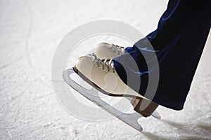 Human feet in fads standing on ice