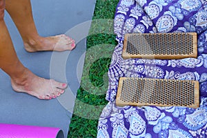 human feet after standing on yoga nail desk sadhu closeup photo on green grass background