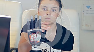 Human female touchs innovative robotic cybernetic arm. Ultramodern robotic technology concept.