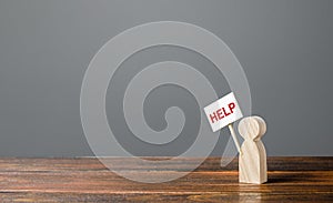 A human figurine asking for help. Support and assistance, providing funding and information to solve social problems. Frequently