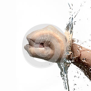 human fist beats through the water with splash, isolated on a white background, copy space