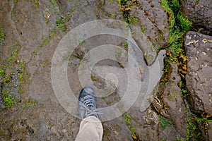 Human foot compared to a dinosaur footprint on the An Corran Beach, near Skye, Portree