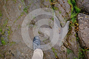 Human foot compared to a dinosaur footprint on the An Corran Beach, near Skye, Portree photo