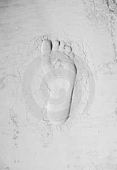 Human footprint in cement. Labor day and hard work idea. Minimal abstract civilization progress concept