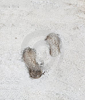 Human footprints on cement floors of walkway