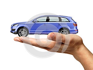 Human hand with a car on the palm.