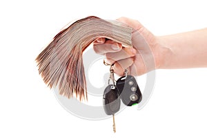 Human hand with cash and car keys