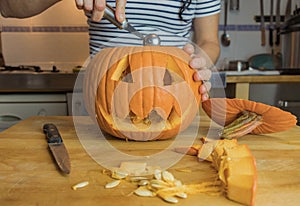 Human hand cleaning pumpkin