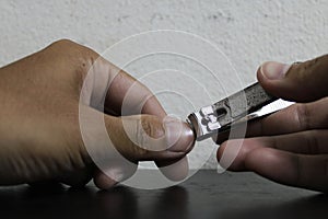 A human hand clipping a fingernails.
