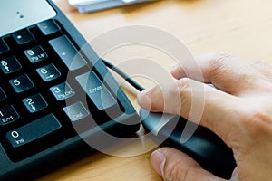 Human hand on computer mouse