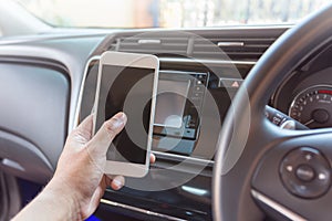 Human hand conecting smart phone and car. photo
