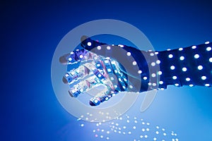 human hand covered with blue led lights, illuminated background