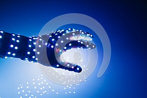 human hand covered with blue led lights, illuminated background