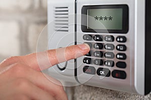 Human Hand Entering Security System Code