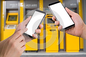 Human hand hold and touch smartphone, tablet, cell phone with blank screen, virtual internet banking on blurry cash machines