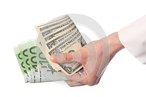 Human hand holding banknotes (euro and dollar)