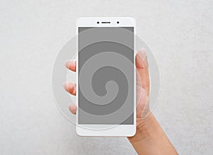 Human hand holding blank screen smart phone  on white background.