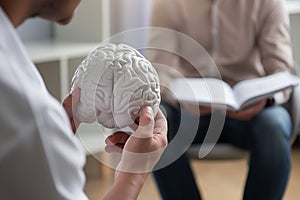 human hand holding brain symbiol, study of brain activity