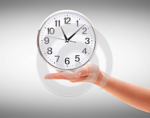 Human Hand Holding Clock Time on white