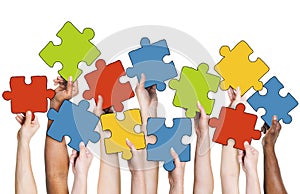 Human Hand Holding Colourful Jigsaw Puzzle Pieces