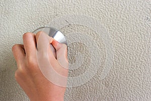 Human hand holding Door knob to open into the house.