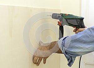 Human hand holding drill machine