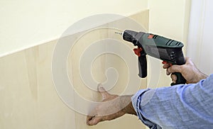 Human hand holding drill machine