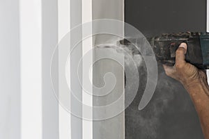 Human hand holding drilling machine